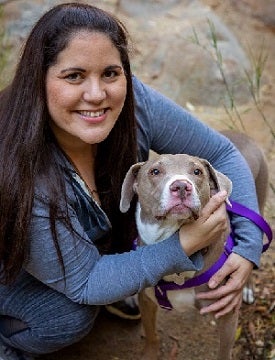 Woman hugging brown dog