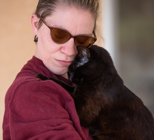 Person hugging cat