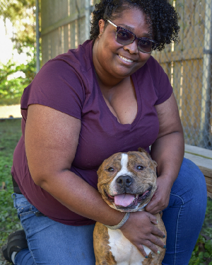 Woman kneeling next to dog