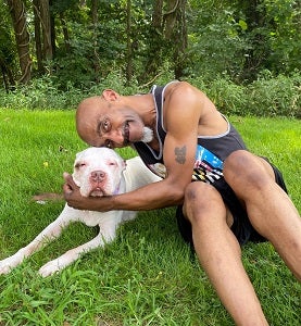 Man sitting in grass with dog