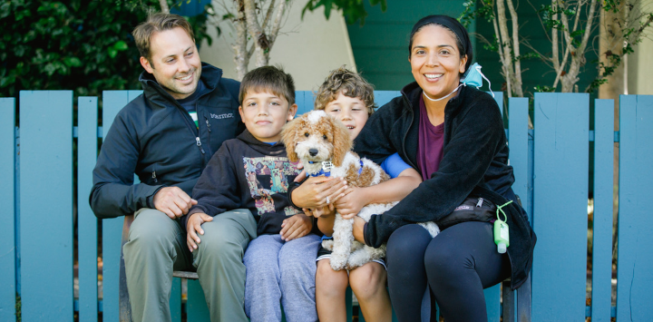 Mom, Dad, and two children with their newly adopted dog